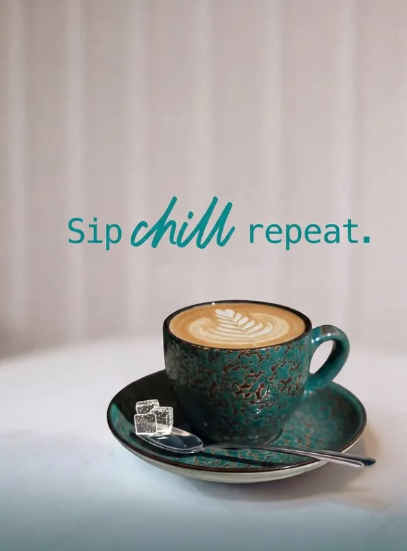 Cappuccino with latte art in a teal ceramic cup